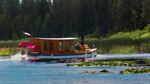 Al Dunlap's boat, the Cheng-Tze, rounds a bend in a canal on Klamath Lake. Dunlap built his entire boat by hand, and modeled it after historic steam yachts.