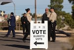 Police officers stand outside a polling station in Las Vegas on Election Day, Nov. 5, 2024. In recent years, election administrators have formed closer working relationships with local law enforcement.