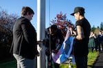 An updated version of the transgender pride flag is raised to half-staff to commemorate Transgender Day of Remembrance. Black and brown stripes appear on the flag alongside the original blue, pink and white. The added stripes represent black and brown people.  