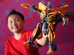 A boy holds a Transformers robot figure in 2011. The toys that became a global sensation started out as transforming robot toys in Japan in the early 1980s.