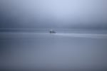 A boat is shown through the morning fog on Wednesday, December 6, 2017, during a King Tide in Olympia.