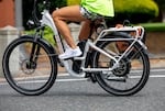 A person rides an e-bike in Vancouver, Wash., on June 29, 2024. The majority of e-bikes are manufactured in China, they would be subject to tariffs endorsed by President Donald Trump.
