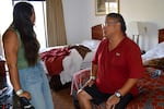 Warm Springs tribal members Cajun Scott, left, and Flint Scott sit at a motel in Madras, Ore., on July 30, 2026, after the Bench Fire burned his property and other homes.