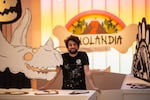 Portland-based visual artist Mike Bennett poses inside Dinolandia, a pop-up museum he created inside a former department store in downtown Portland featuring nearly 70 dinosaur plywood cutouts he and his team constructed and painted. The museum runs from May 31 through Sept. 10, 2022.