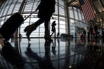 A traveler at Ronald Reagan Washington National Airport walks to a Transportation Security Administration checkpoint on Nov. 26, 2014.