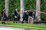 Law enforcement officials work at the crime scene outside the Trump International Golf Club in West Palm Beach, Fla. on September 16, 2024, the day after the attempted assassination of then-GOP presidential candidate Donald Trump.