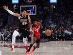 Houston Rockets guard Jalen Green, right, drives against Portland Trail Blazers forward Justin Minaya during the second half of an NBA basketball game Friday, April 12, 2024, in Portland, Ore. (AP Photo/Howard Lao)