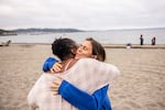 Audrey Nassal, right, hugs plunger Mikki Smith. Nassal started this group's Sunday morning dip earlier this year. As the gathering has grown, she has refined her pitch to anyone who might be tempted to join: "Most people will say, 'I don't like the cold. This is crazy. But I think a lot of times that's a story that people tell themselves."