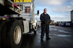 Thomas Van Hoose stands in front of a truck he drives for deliveries at Swift Steel.
