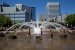 Children play in the fountain at the Portland Waterfront as the temperature rises to more than 100 degrees Fahrenheit.