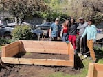 Devin Fitzpatrick, first from right, joined students from his "Data for Good" class to help Growing Gardens build a community garden at Cascadia Health in Portland, Ore., in April 2025.