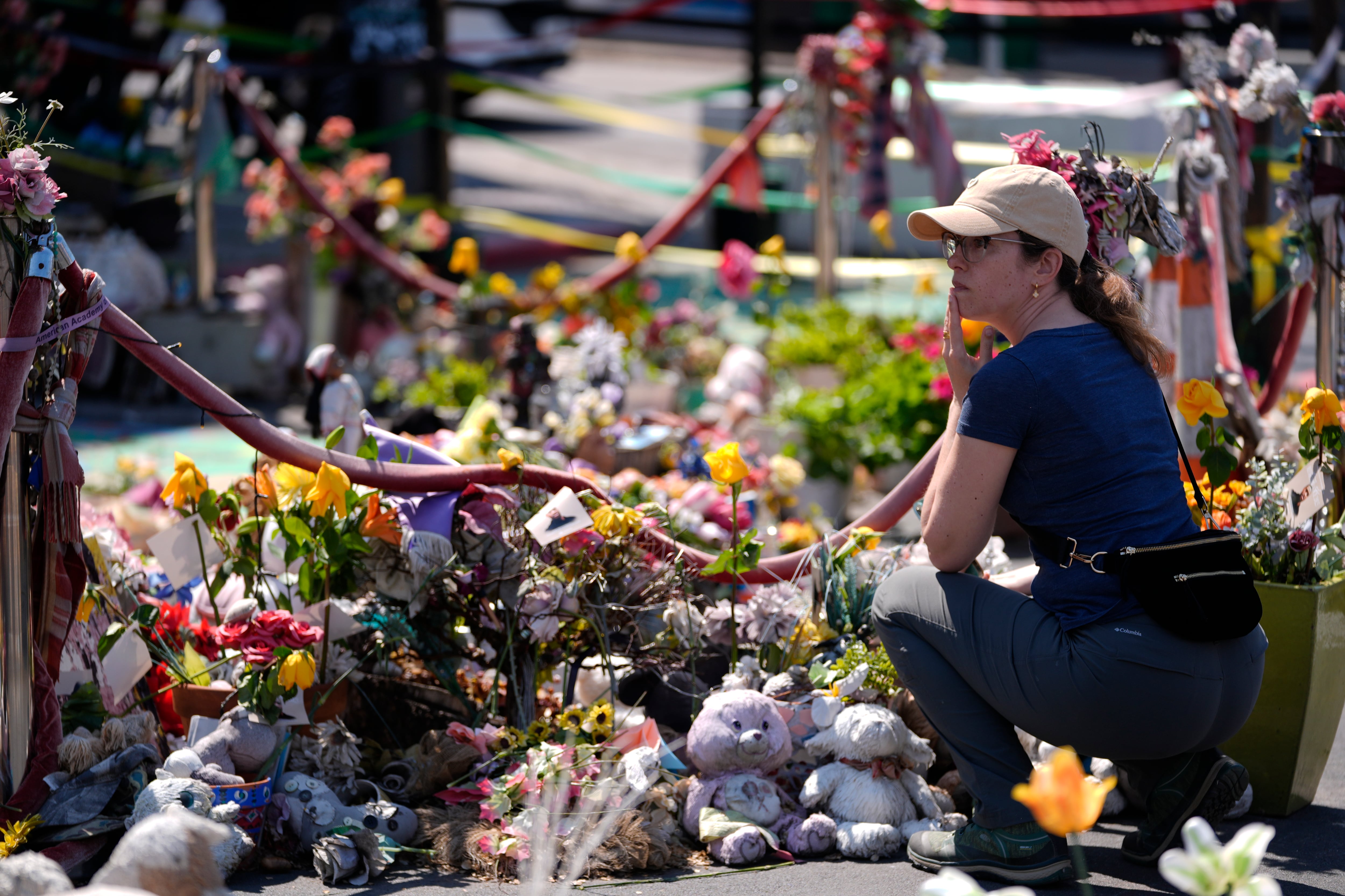A person visits the spot of George Floyd's murder at George Floyd Square on the fifth anniversary of Floyd's death, Sunday, May 25, 2025, in Minneapolis. Portland joins numerous cities across the country for the commemoration this weekend.