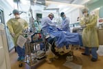 Staff prepare to perform a surgical procedure on the ICU floor of Oregon Health and Science University in Portland, Ore., Aug. 19, 2021. As of Aug. 27, 26 COVID-19 patients were in OHSU's ICU.