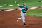 Seattle Mariners' Cal Raleigh celebrates his solo home run as he rounds the bases against the Toronto Blue Jays during the sixth inning in Game 1 of baseball's American League Championship Series, Sunday, Oct. 12, 2025, in Toronto.