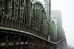 Traffic travels on the Interstate 5 bridge that spans the Columbia River and connects Portland, Ore., with southwest Washington state on Tuesday, Feb. 13, 2024, as seen from near the Washington state entrance to the bridge.