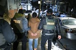 Law enforcement walk with Leonardo Fabian Cando Juntamay as he was detained in the Bronx during ICE-led operations to apprehend illegal immigrants on Jan. 28, 2025 in New York, NY. (Photo by Matt McClain/The Washington Post via Getty Images)
