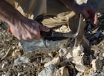 Sammy Castonguay breaks rocks from the McDermitt Caldera into samples for his geology students.