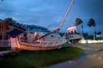 Boats rest in a yard after they were washed ashore when Hurricane Milton passed through the area in Punta Gorda, Florida. The storm made landfall as a Category 3 hurricane in the Siesta Key area of Florida, causing damage and flooding throughout Central Florida.