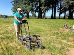 Researcher and Northern Cheyenne tribal member Marsha Small uses ground-penetrating radar in the cemetery at Chemawa Indian School in summer 2021.