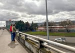 Aidan Hanley, left, and Cooper Bulens, right, take notes of their observations on an overpass over Interstate 5 during a place-based lesson March 13, 2024. Hanley and Bulens are teaching candidates in the Lewis & Clark graduate school.