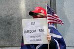 A person holds a sign that reads "Let Freedom Ring, Investigate Voter Fraud," during a rally, Sunday, Jan. 10, 2021, at the Capitol in Olympia, Wash. Protesters from several causes rallied Sunday at the Capitol, the day before the 2021 legislative session was scheduled to begin.