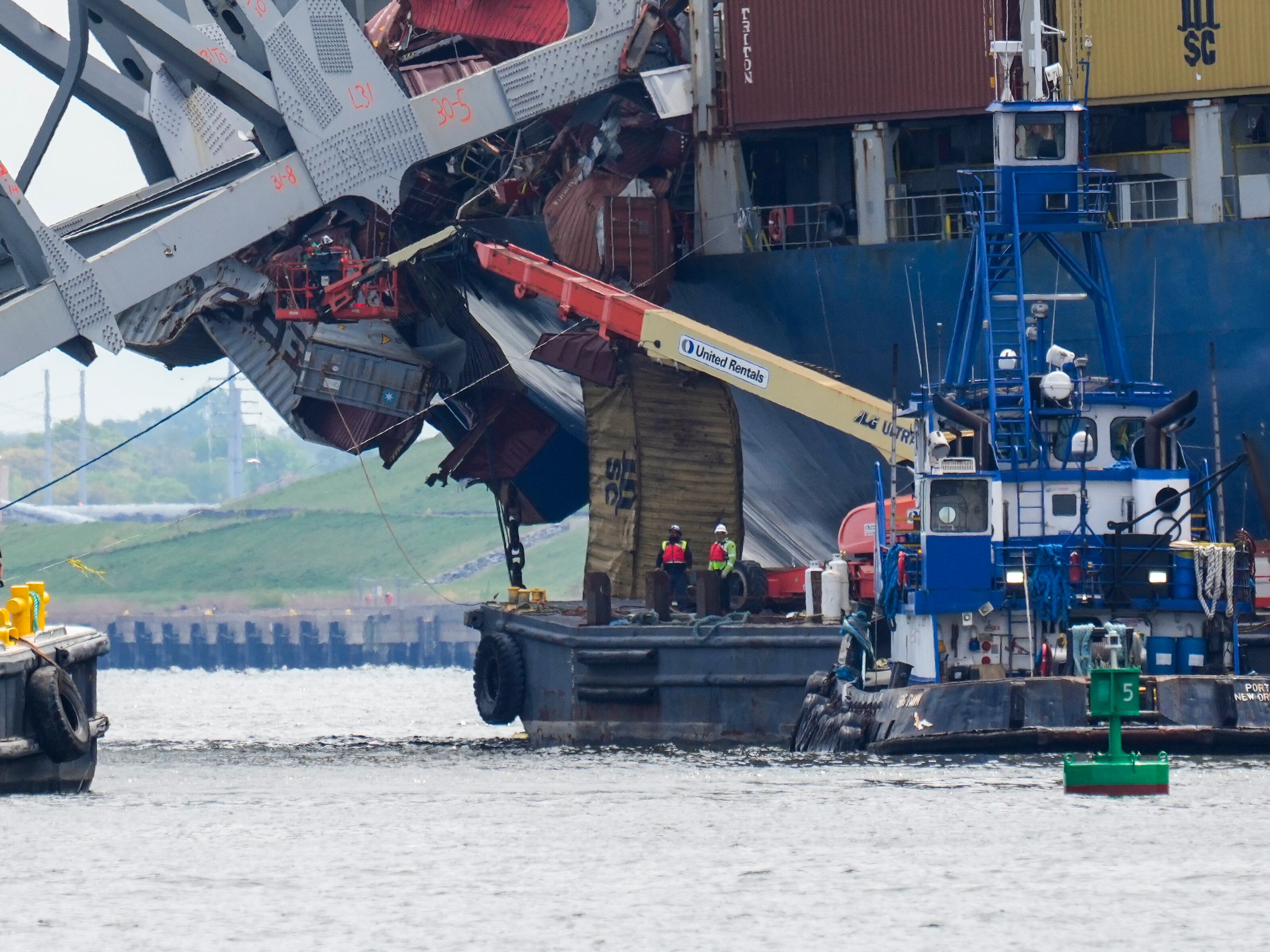 Workers remove wreckage of the collapsed Francis Scott Key Bridge, Thursday, April 25, 2024, in Baltimore.