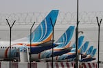 FlyDubai airline planes are parked at Dubai International Airport on Monday. Several Persian Gulf airlines — including those based in Dubai and Abu Dhabi in the United Arab Emirates, Doha in Qatar and others — have curtailed commercial flights for safety reasons following the expanding U.S. and Israeli bombardment in Iran.