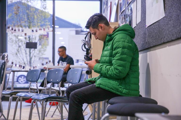 Angel Rodriguez checks his phone prior to a youth town hall on the American Dream at The CENTER in North Portland on Tuesday, Oct. 25, 2016.