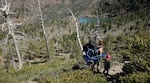 Jill Stokes hikes with her daughter Azalea to a secluded lake.