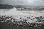 Waves crash onto the beach in Kingston on October 27, 2025. Hurricane Melissa threatened Jamaica with potentially deadly rains after rapidly intensifying into a top-level Category 5 storm, as residents scrambled for shelter from what could be the island's most violent weather on record.