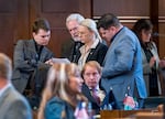 Members of the Oregon Senate talk on the Senate floor Friday at the Capitol in Salem, Ore. The Senate approved House Bill 4002, which passed yesterday in the House. Sen. Kate Lieber (center, standing) a Democrat from Portland, was one of the architects of the bill. Sen. Tim Knopp (seated in front of Lieber), a Republican from Bend and the Minority Leader, said the bipartisan bill was a response to the will of Oregonians.