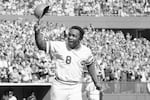 In this Saturday, Oct. 16, 1976, file photo, Cincinnati Reds second baseman Joe Morgan tips his helmet to the fans as he rounds the bases after a homer in the first inning against the New York Yankees at Riverfront Stadium in Cincinnati. Hall of Fame second baseman Joe Morgan has died. A family spokesman says he died at his home Sunday, Oct. 11, 2020, in Danville, Calif.