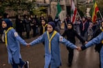 Members of the Imam al-Mahdi Scouts, Hezbollah's youth group, march to a graveyard to bury one of the seven members of the Berjawi family.