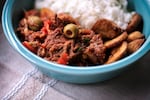 Hearty, deeply flavored Ropa Vieja is served with white rice and fried plantains. To prepare this dish at home, you can cook the flank steak on the stovetop or in a pressure cooker or slow cooker.