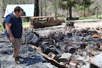 Dwayne Canfield, interim director of the Opal Creek Ancient Forest Center, walks among the remains of a building that burned in the Beachie Creek Fire last year.