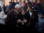 Palestinians mourn relatives killed in the Israeli bombardment of the Gaza Strip outside a morgue in Khan Younis on Sunday, Dec. 24, 2023.