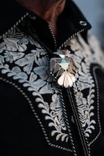 Martin Hash wears a bolo tie made in the late 1940s, designed by Native American artists, and gifted to him by his grandfather. Hash says his bolo tie collection numbers around 100. 