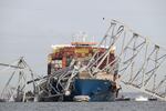 The steel frame of the Francis Scott Key Bridge sits on top of the container ship Dali after the bridge collapsed, Baltimore, Md., on March 26, 2024. 