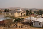 The hills behind Fossil Elementary are hazy with wildfire smoke from the Rowe Creek Complex Fire on Tuesday, July 21, 2026.