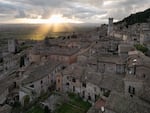 A sunset seen from the city of Assisi, a UNESCO World Heritage Site in Umbria, Italy, renowned as the birthplace of St. Francis and famous for its medieval architecture, basilicas and breathtaking views over the valley.