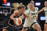 FILE - Portland Fire guard Sarah Ashlee Barker, left, tries to get past Chicago Sky guard Rachel Banham (24) during the first half of a WNBA basketball game on Saturday, May 9, 2026, in Portland, Ore.