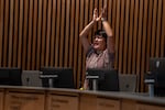 Portland city councilor Tiffany Koyama Lane of District 3 cheers for the performance.