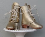 Allison Wonder creates handmade shoes and boots, with real stacked leather heels and lots of tiny grommets.