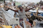 A woman gestures in front of her demolished house in Otodo-Gbame waterfront in Lagos, Nigeria. Saturday, March 18, 2017. Slums and shantytowns are often targeted in rampant demolitions across Africa’s most populous country