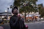 Joseph Grayson blows bubbles in front of the U.S. Immigration and Customs Enforcement building in Portland, Ore. on Oct. 10, 2025.