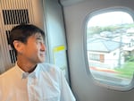 Naoyuki Ueno with the Central Japan Railway Company watches the Japanese landscape rush by from a window on the Shinkansen.