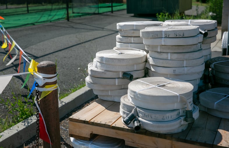 Rolled-up firehoses in the staging area behind Baker City High School.