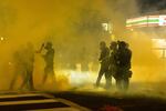 Police use tear gas and impact munitions to disperse protesters in downtown Portland during 4th of July demonstrations against systemic racism and police violence. 