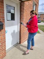 Sarah Harrison knocks on doors for Democrats on March 17 in Waukesha, Wisc., working through a list of 29 addresses that the party database said were home to likely Democratic voters.