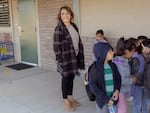 Kindergarten teacher Lupe Fuentes waits with students for class to start at Selma Herndon Elementary.